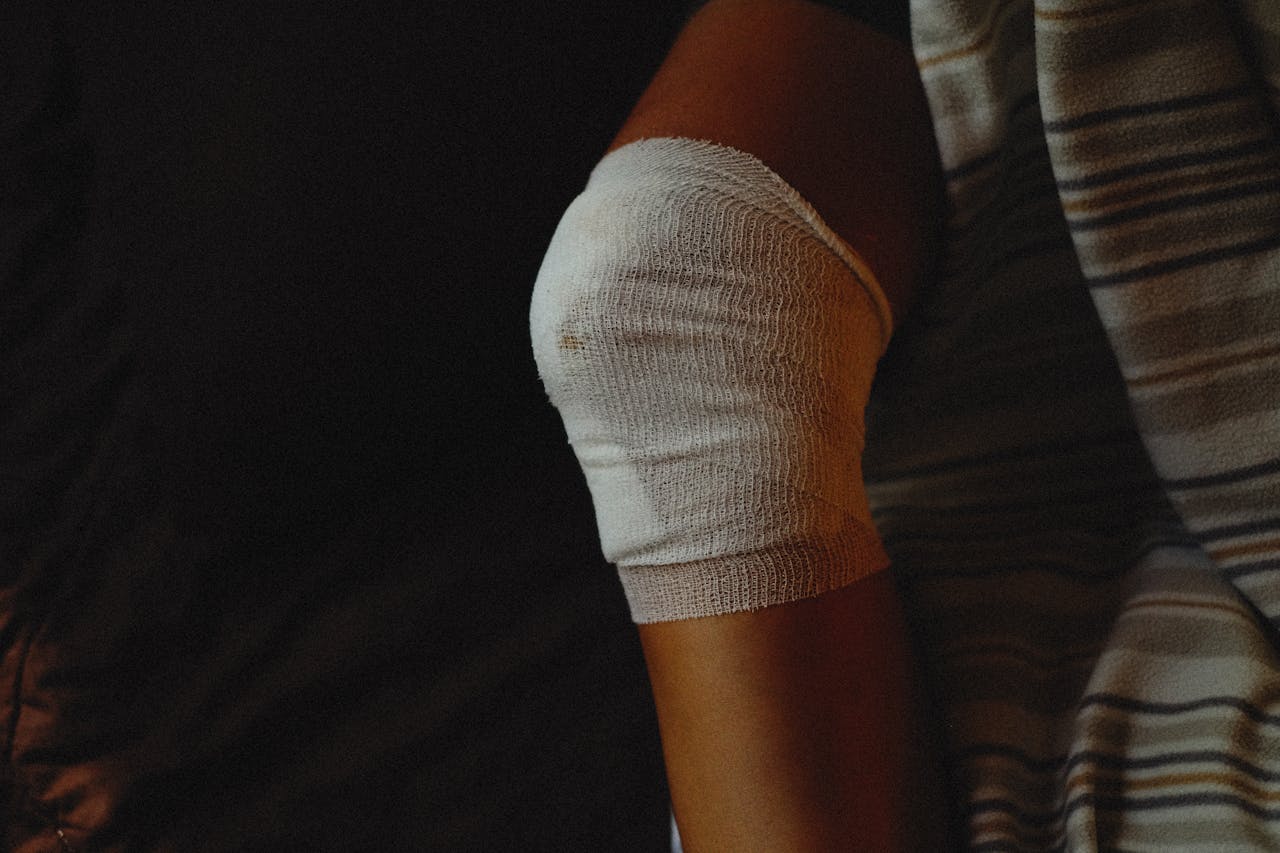 A detailed view of a bandaged knee indicating injury care and healing process.